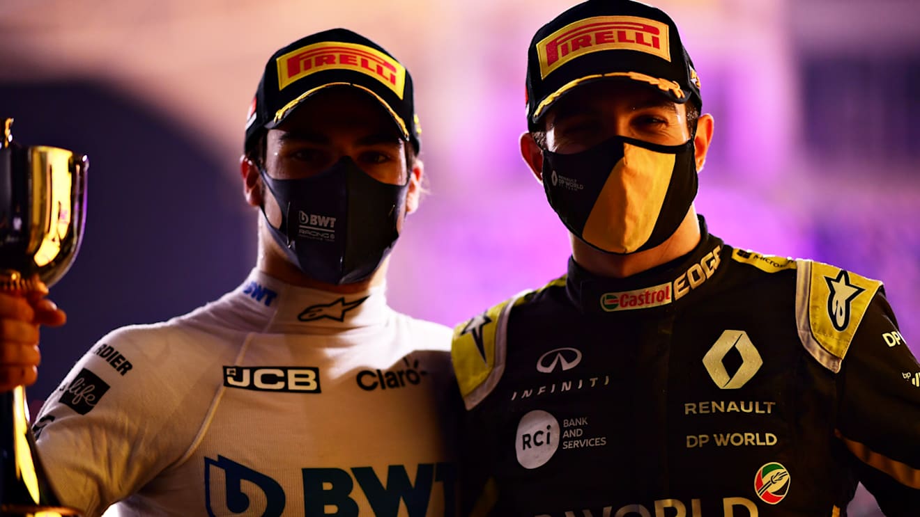BAHRAIN, BAHRAIN - DECEMBER 06: Second placed Esteban Ocon of France and Renault Sport F1 and third placed Lance Stroll of Canada and Racing Point celebrate on the podium during the F1 Grand Prix of Sakhir at Bahrain International Circuit on December 06, 2020 in Bahrain, Bahrain. (Photo by Mario Renzi - Formula 1/Formula 1 via Getty Images)