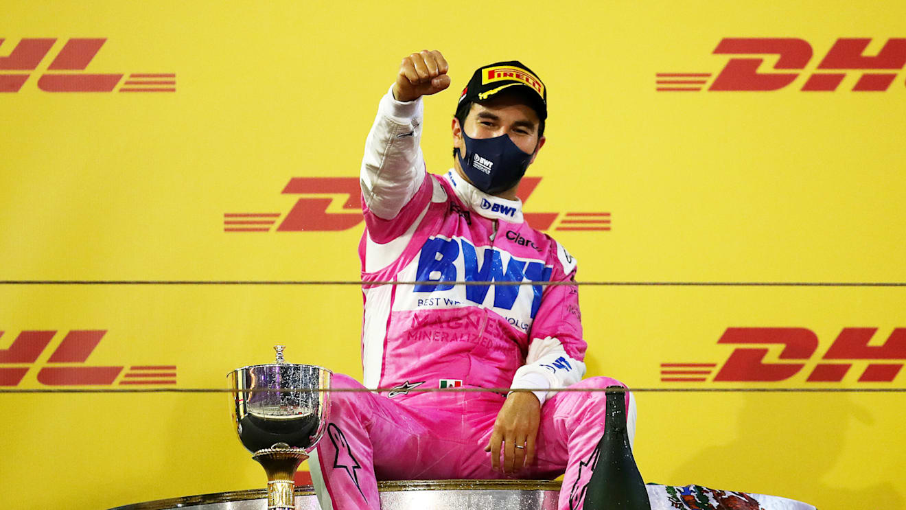 BAHRAIN, BAHRAIN - DECEMBER 06: Race winner Sergio Perez of Mexico and Racing Point celebrates his maiden F1 victory on the podium during the F1 Grand Prix of Sakhir at Bahrain International Circuit on December 06, 2020 in Bahrain, Bahrain. (Photo by Bryn Lennon/Getty Images)