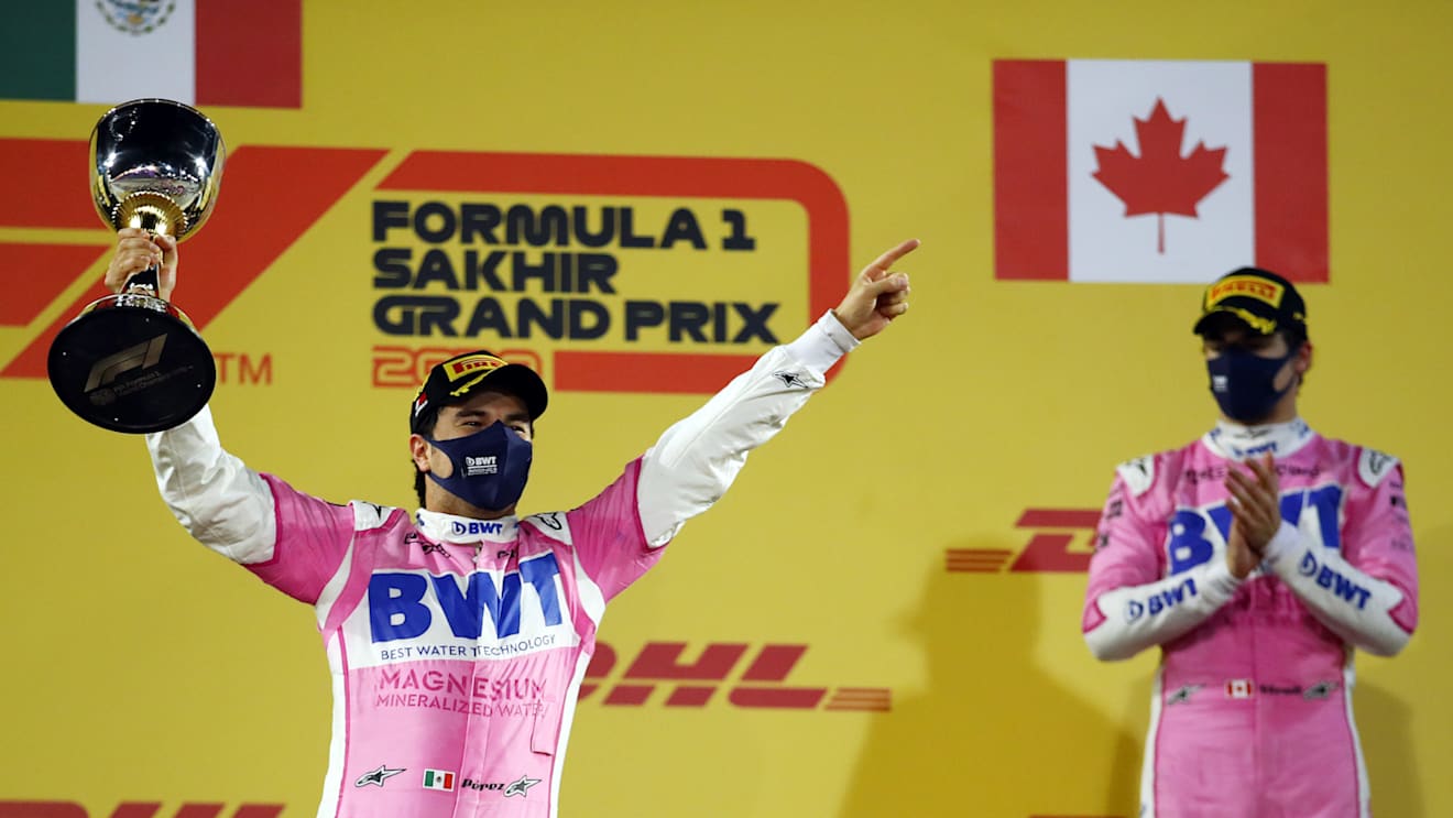 BAHRAIN, BAHRAIN - DECEMBER 06: Race winner Sergio Perez of Mexico and Racing Point celebrates his maiden F1 victory on the podium during the F1 Grand Prix of Sakhir at Bahrain International Circuit on December 06, 2020 in Bahrain, Bahrain. (Photo by Bryn Lennon/Getty Images)