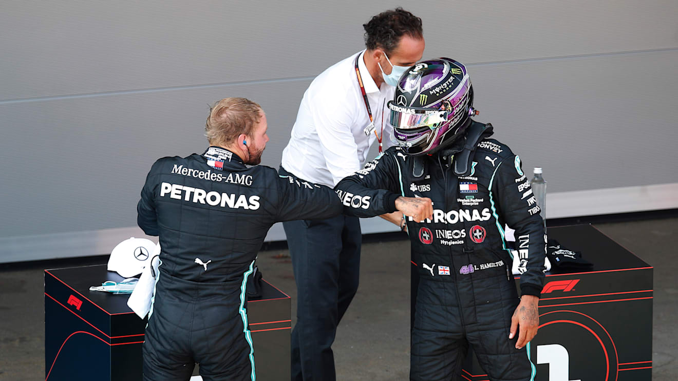BARCELONA, SPAIN - AUGUST 15: Second placed qualifier Valtteri Bottas of Finland and Mercedes GP and Pole position qualifier Lewis Hamilton of Great Britain and Mercedes GP celebrate in parc ferme during qualifying for the F1 Grand Prix of Spain at Circuit de Barcelona-Catalunya on August 15, 2020 in Barcelona, Spain. (Photo by Alejandro Garcia/Pool via Getty Images)