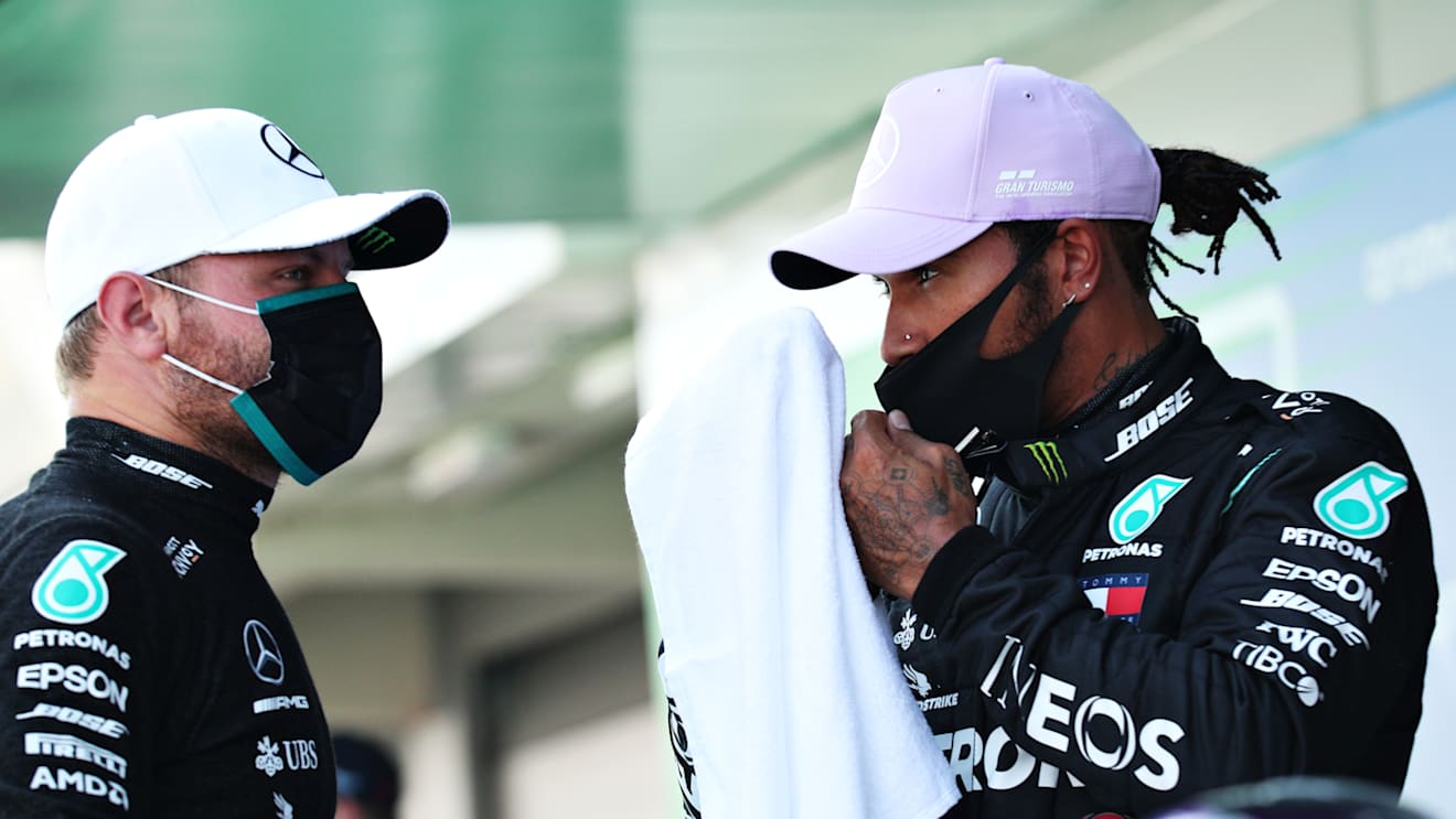 BARCELONA, SPAIN - AUGUST 15: Pole position qualifier Lewis Hamilton of Great Britain and Mercedes GP talks to second placed qualifier Valtteri Bottas of Finland and Mercedes GP during qualifying for the F1 Grand Prix of Spain at Circuit de Barcelona-Catalunya on August 15, 2020 in Barcelona, Spain. (Photo by Albert Gea/Pool via Getty Images)