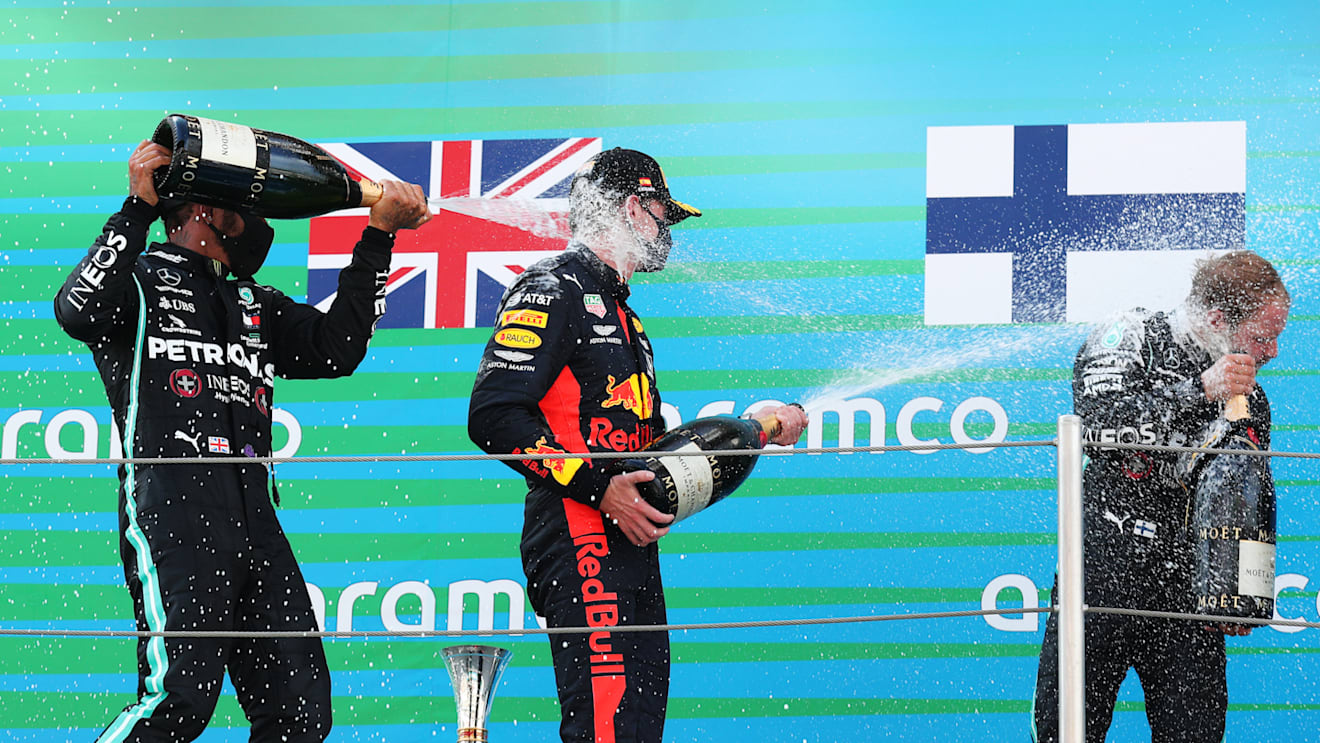 BARCELONA, SPAIN - AUGUST 16: Race winner Lewis Hamilton of Great Britain and Mercedes GP,  second placed Max Verstappen of Netherlands and Red Bull Racing and third placed Valtteri Bottas of Finland and Mercedes GP celebrate on the podium during the F1 Grand Prix of Spain at Circuit de Barcelona-Catalunya on August 16, 2020 in Barcelona, Spain. (Photo by Albert Gea/Pool via Getty Images)