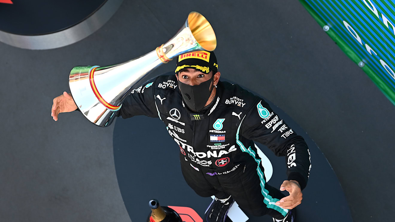 BARCELONA, SPAIN - AUGUST 16: Race winner Lewis Hamilton of Great Britain and Mercedes GP celebrates on the podium by throwing his trophy in the air during the F1 Grand Prix of Spain at Circuit de Barcelona-Catalunya on August 16, 2020 in Barcelona, Spain. (Photo by Clive Mason - Formula 1/Formula 1 via Getty Images)