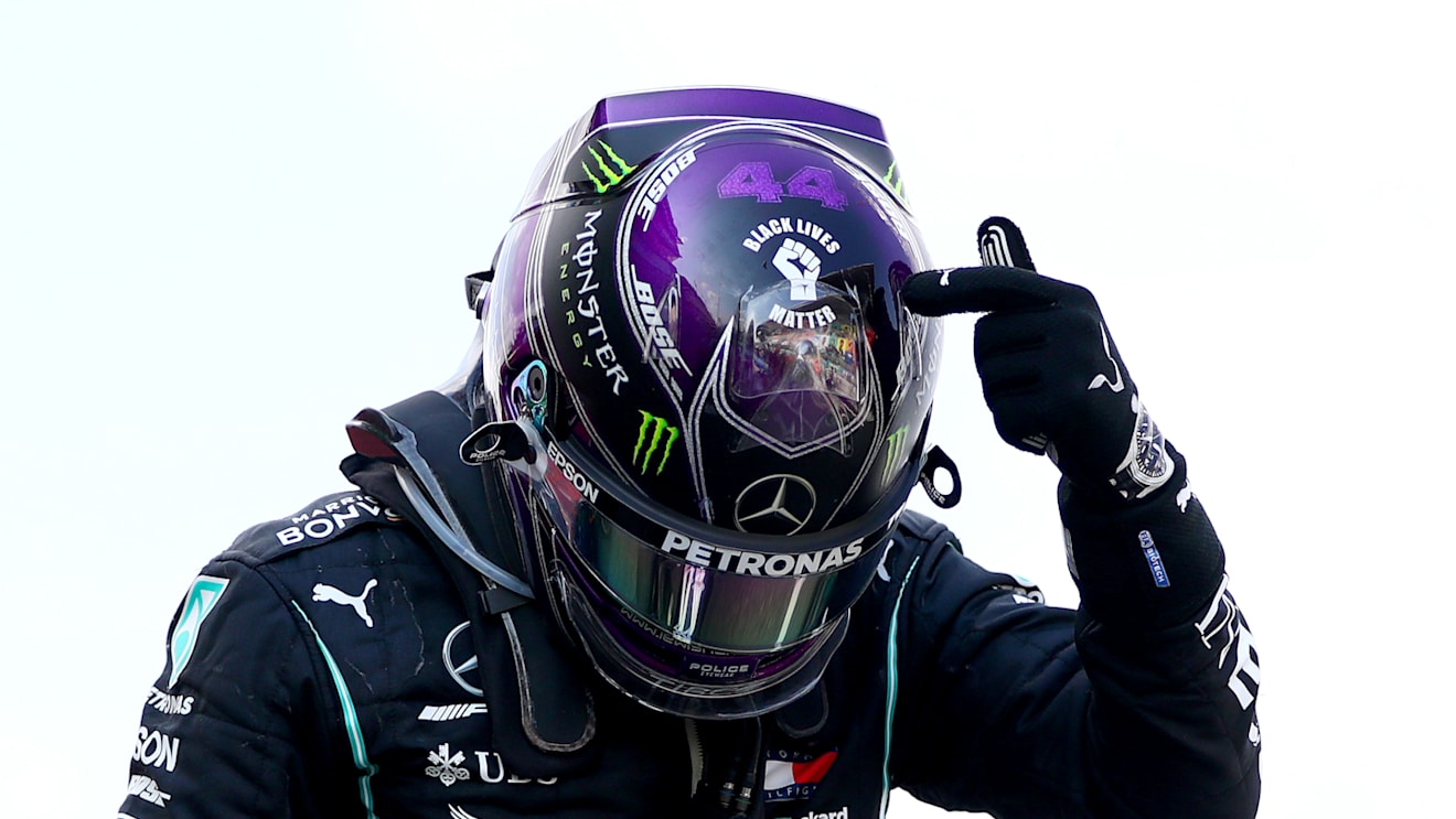 BARCELONA, SPAIN - AUGUST 16: Race winner Lewis Hamilton of Great Britain and Mercedes GP points to the 'Black Lives Matter' symbol on his helmet as he celebrates in parc ferme during the F1 Grand Prix of Spain at Circuit de Barcelona-Catalunya on August 16, 2020 in Barcelona, Spain. (Photo by Dan Istitene - Formula 1/Formula 1 via Getty Images)