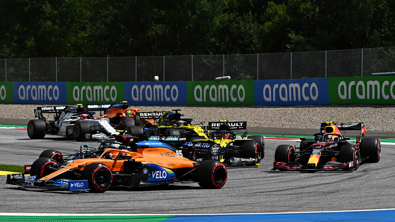 SPIELBERG, AUSTRIA - JULY 12:Carlos Sainz of Spain driving the (55) McLaren F1 Team MCL35 Renault and Valtteri Bottas of Finland driving the (77) Mercedes AMG Petronas F1 Team Mercedes W11 battle for position ahead of Alexander Albon of Thailand driving the (23) Aston Martin Red Bull Racing RB16 during the Formula One Grand Prix of Styria at Red Bull Ring on July 12, 2020 in Spielberg, Austria. (Photo by Clive Mason - Formula 1/Formula 1 via Getty Images)