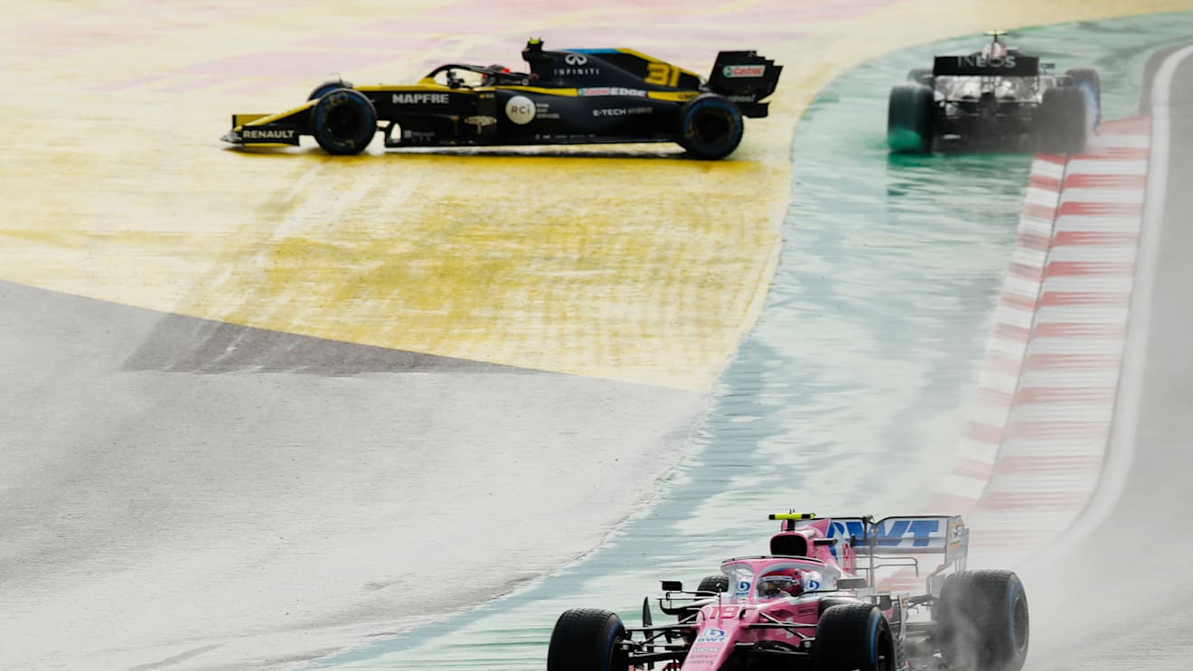 ISTANBUL, TURKEY - NOVEMBER 15: Lance Stroll of Canada driving the (18) Racing Point RP20 Mercedes leads the rest of the field as Esteban Ocon of France driving the (31) Renault Sport Formula One Team RS20 and Valtteri Bottas of Finland driving the (77) Mercedes AMG Petronas F1 Team Mercedes W11 spin off at the start during the F1 Grand Prix of Turkey at Intercity Istanbul Park on November 15, 2020 in Istanbul, Turkey. (Photo by Murad Sezer - Pool/Getty Images)
