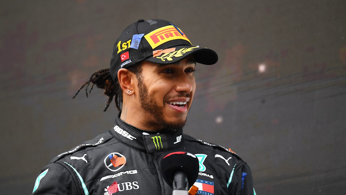 ISTANBUL, TURKEY - NOVEMBER 15: Race winner Lewis Hamilton of Great Britain and Mercedes GP talks to the media on the podium after winning a 7th F1 World Drivers Championship during the F1 Grand Prix of Turkey at Intercity Istanbul Park on November 15, 2020 in Istanbul, Turkey. (Photo by Clive Mason/Getty Images)