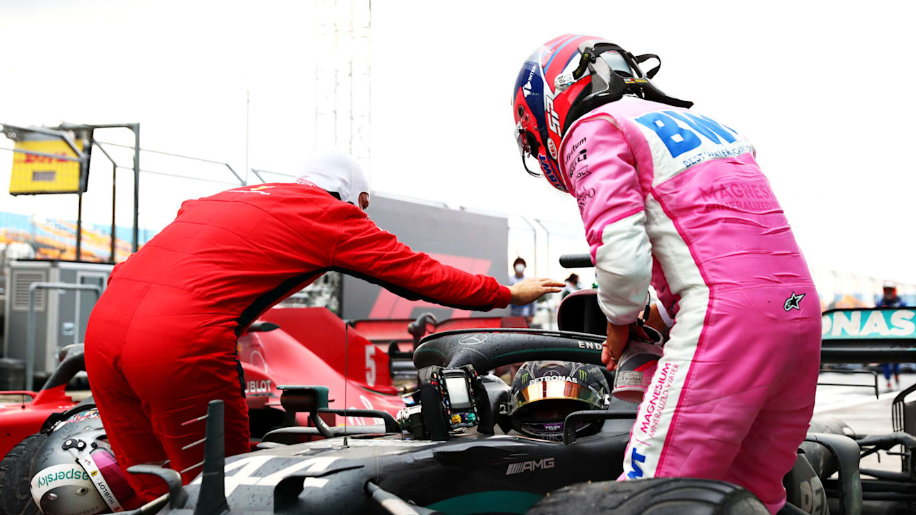 ISTANBUL, TURKEY - NOVEMBER 15: Race winner Lewis Hamilton of Great Britain and Mercedes GP is congratulated by Sebastian Vettel of Germany and Ferrari and Sergio Perez of Mexico and Racing Point in parc ferme after winning a 7th F1 World Drivers Championship during the F1 Grand Prix of Turkey at Intercity Istanbul Park on November 15, 2020 in Istanbul, Turkey. (Photo by Dan Istitene - Formula 1/Formula 1 via Getty Images)