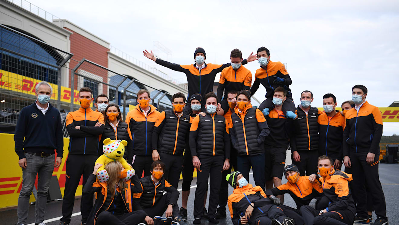 ISTANBUL, TURKEY - NOVEMBER 15: Lando Norris of Great Britain and McLaren F1 and team members pose with a Pudsey Bear toy on the grid after the F1 Grand Prix of Turkey at Intercity Istanbul Park on November 15, 2020 in Istanbul, Turkey. (Photo by Clive Mason/Getty Images)