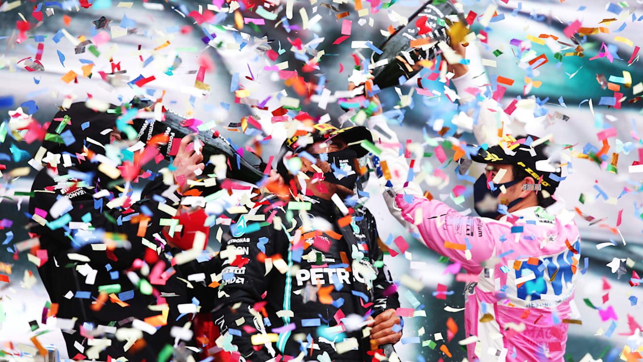 ISTANBUL, TURKEY - NOVEMBER 15: Race winner Lewis Hamilton of Great Britain and Mercedes GP celebrates winning a 7th F1 World Drivers Championship with second placed Sergio Perez of Mexico and Racing Point Third placed Sebastian Vettel of Germany and Ferrari and Mercedes GP Executive Director Toto Wolff on the podium during the F1 Grand Prix of Turkey at Intercity Istanbul Park on November 15, 2020 in Istanbul, Turkey. (Photo by Tolga Bozoglu - Pool/Getty Images)