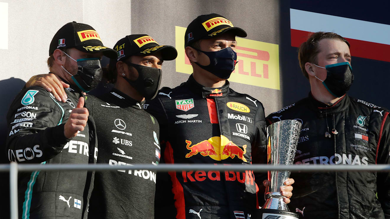 SCARPERIA, ITALY - SEPTEMBER 13: Race winner Lewis Hamilton of Great Britain and Mercedes GP, second placed Valtteri Bottas of Finland and Mercedes GP and third placed Alexander Albon of Thailand and Red Bull Racing celebrate on the podium during the F1 Grand Prix of Tuscany at Mugello Circuit on September 13, 2020 in Scarperia, Italy. (Photo by Luca Bruno - Pool/Getty Images)