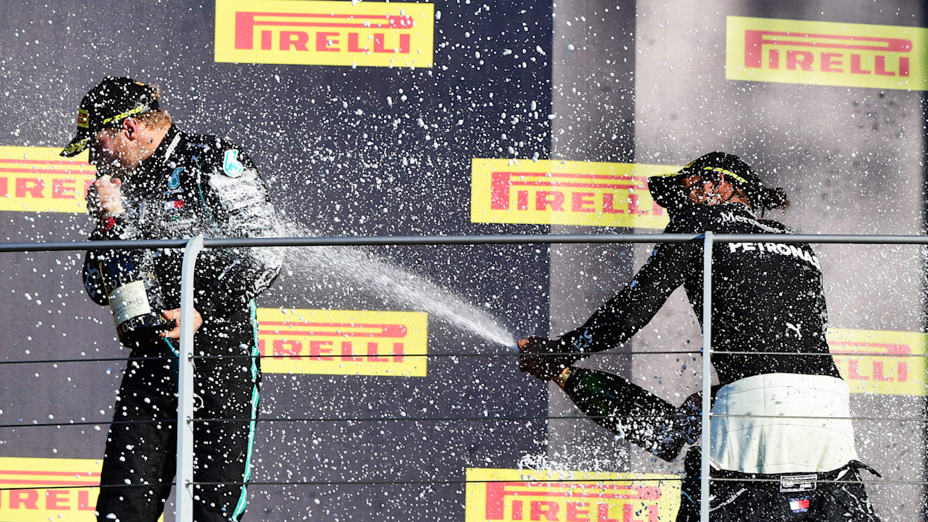 SCARPERIA, ITALY - SEPTEMBER 13: Race winner Lewis Hamilton of Great Britain and Mercedes GP and second placed Valtteri Bottas of Finland and Mercedes GP celebrate on the podium during the F1 Grand Prix of Tuscany at Mugello Circuit on September 13, 2020 in Scarperia, Italy. (Photo by Jenifer Lorenzini - Pool/Getty Images)