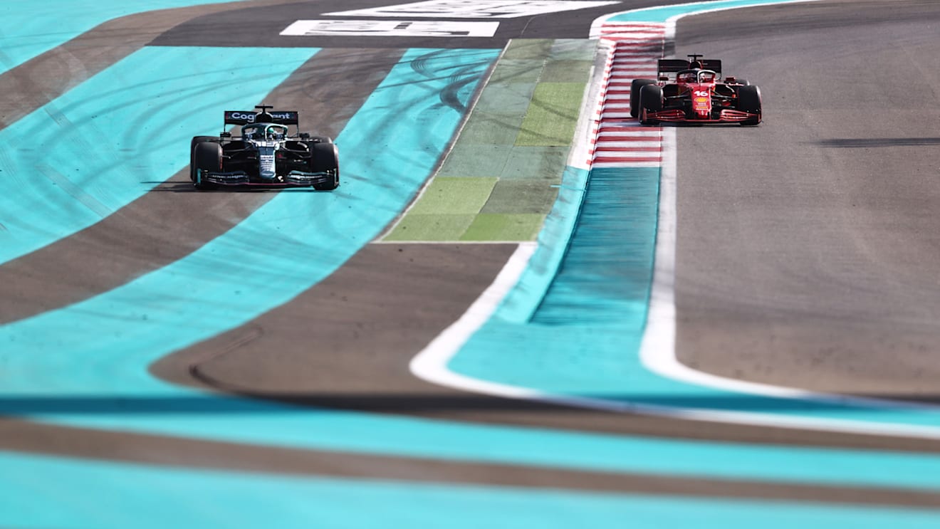 ABU DHABI, UNITED ARAB EMIRATES - DECEMBER 10: Lance Stroll of Canada driving the (18) Aston Martin AMR21 Mercedes and Charles Leclerc of Monaco driving the (16) Scuderia Ferrari SF21  during practice ahead of the F1 Grand Prix of Abu Dhabi at Yas Marina Circuit on December 10, 2021 in Abu Dhabi, United Arab Emirates. (Photo by Mark Thompson/Getty Images)