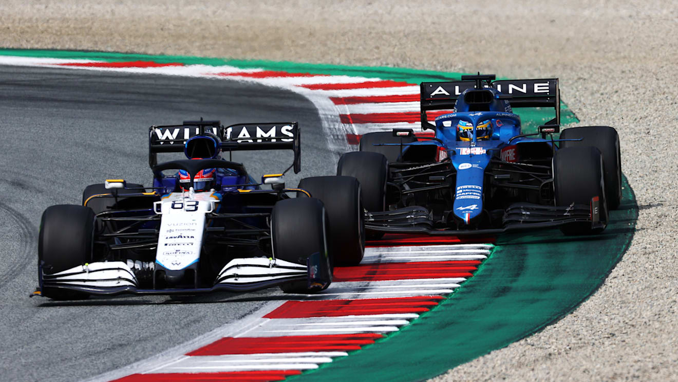 SPIELBERG, AUSTRIA - JULY 04: George Russell of Great Britain driving the (63) Williams Racing FW43B Mercedes leads Fernando Alonso of Spain driving the (14) Alpine A521 Renault during the F1 Grand Prix of Austria at Red Bull Ring on July 04, 2021 in Spielberg, Austria. (Photo by Clive Mason - Formula 1/Formula 1 via Getty Images)