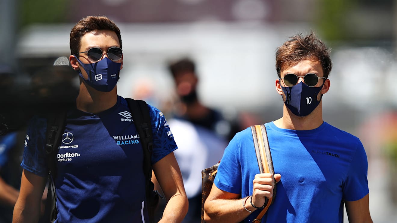 BAKU, AZERBAIJAN - JUNE 05: George Russell of Great Britain and Williams and Pierre Gasly of France and Scuderia AlphaTauri walk in the Paddock before final practice ahead of the F1 Grand Prix of Azerbaijan at Baku City Circuit on June 05, 2021 in Baku, Azerbaijan. (Photo by Mark Thompson/Getty Images)