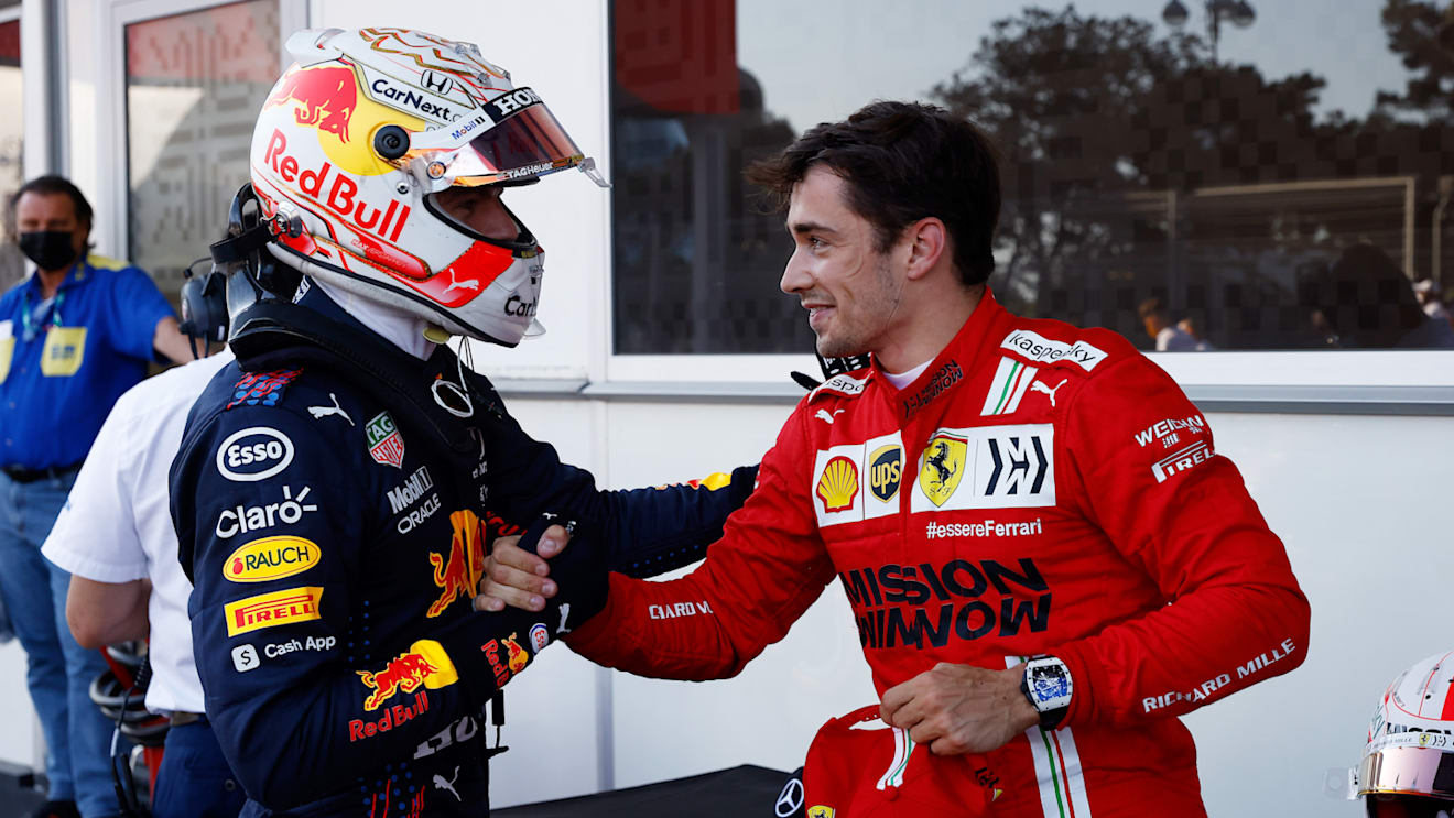 BAKU, AZERBAIJAN - JUNE 05: Third placed qualifier Max Verstappen of Netherlands and Red Bull Racing shakes hands with pole position qualifier Charles Leclerc of Monaco and Ferrari in parc ferme during qualifying ahead of the F1 Grand Prix of Azerbaijan at Baku City Circuit on June 05, 2021 in Baku, Azerbaijan. (Photo by Maxim Shemetov - Pool/Getty Images)