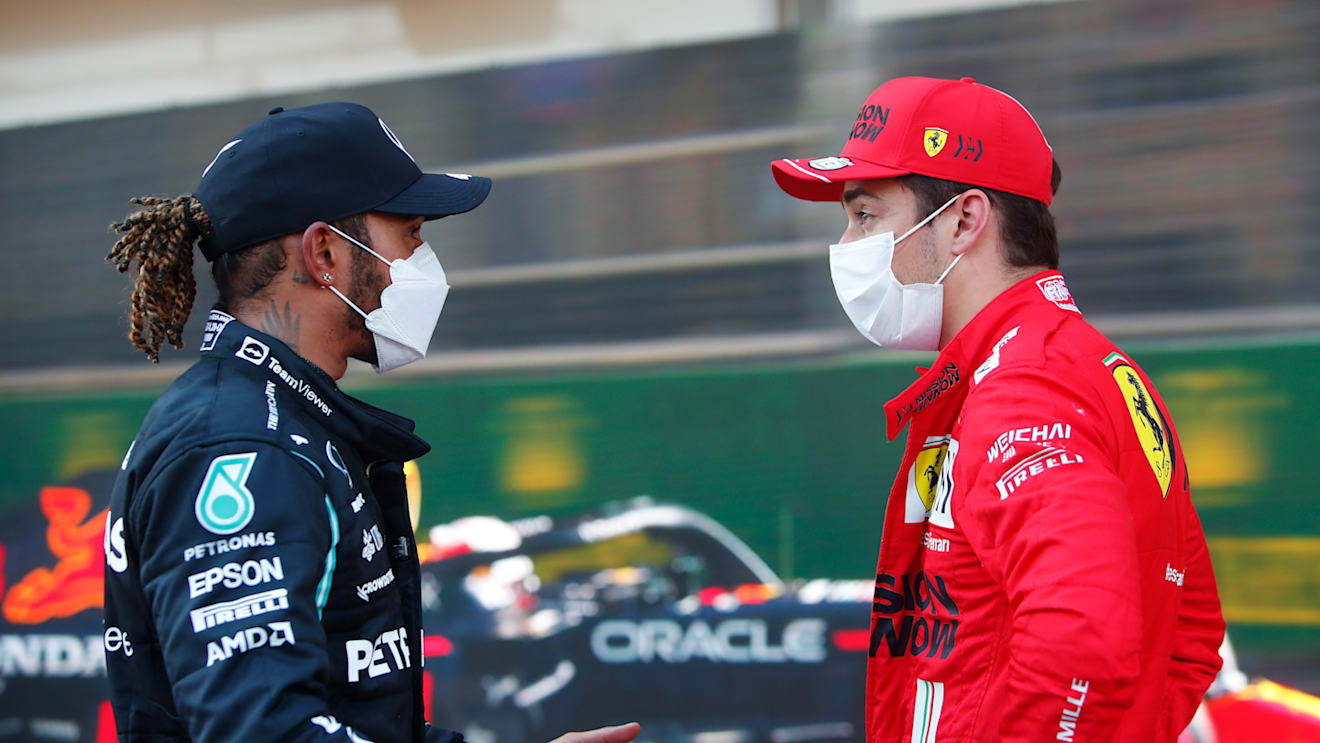 BAKU, AZERBAIJAN - JUNE 05: Second placed qualifier Lewis Hamilton of Great Britain and Mercedes GP talks with pole position qualifier Charles Leclerc of Monaco and Ferrari in parc ferme during qualifying ahead of the F1 Grand Prix of Azerbaijan at Baku City Circuit on June 05, 2021 in Baku, Azerbaijan. (Photo by Maxim Shemetov - Pool/Getty Images)