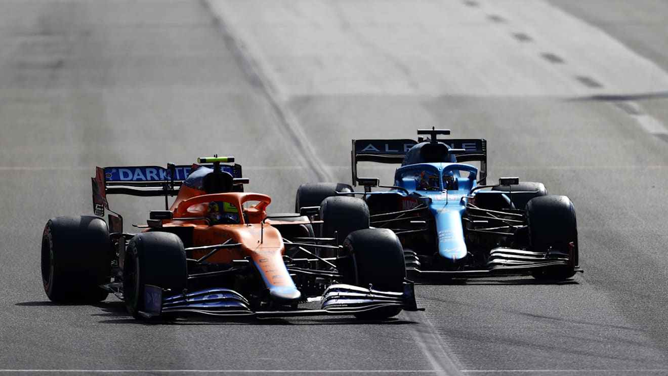 BAKU, AZERBAIJAN - JUNE 06: Lando Norris of Great Britain driving the (4) McLaren F1 Team MCL35M Mercedes and Fernando Alonso of Spain driving the (14) Alpine A521 Renault on track during the F1 Grand Prix of Azerbaijan at Baku City Circuit on June 06, 2021 in Baku, Azerbaijan. (Photo by Francois Nel/Getty Images)