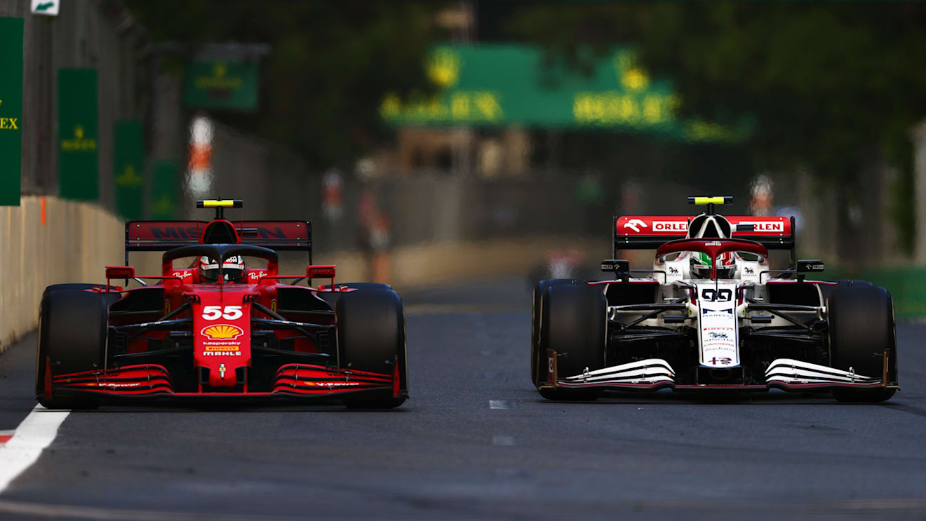 BAKU, AZERBAIJAN - JUNE 06: Carlos Sainz of Spain driving the (55) Scuderia Ferrari SF21 and Antonio Giovinazzi of Italy driving the (99) Alfa Romeo Racing C41 Ferrari battle for track position during the F1 Grand Prix of Azerbaijan at Baku City Circuit on June 06, 2021 in Baku, Azerbaijan. (Photo by Dan Istitene - Formula 1/Formula 1 via Getty Images)