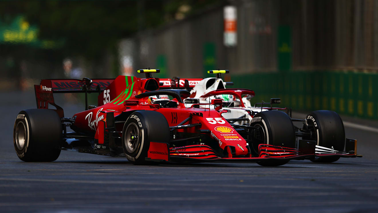 BAKU, AZERBAIJAN - JUNE 06: Carlos Sainz of Spain driving the (55) Scuderia Ferrari SF21 and Antonio Giovinazzi of Italy driving the (99) Alfa Romeo Racing C41 Ferrari battle for track position during the F1 Grand Prix of Azerbaijan at Baku City Circuit on June 06, 2021 in Baku, Azerbaijan. (Photo by Dan Istitene - Formula 1/Formula 1 via Getty Images)
