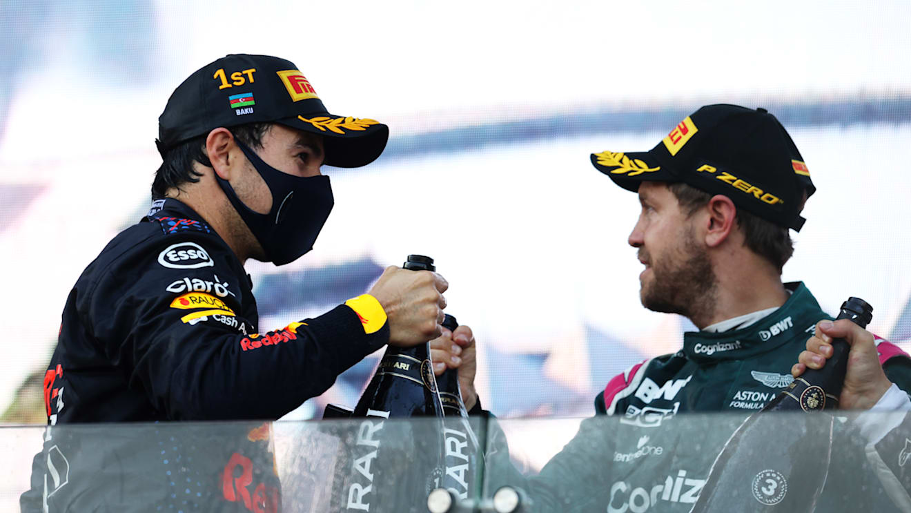 BAKU, AZERBAIJAN - JUNE 06: Race winner Sergio Perez of Mexico and Red Bull Racing and second placed Sebastian Vettel of Germany and Aston Martin F1 Team celebrate with sparkling wine on the podium during the F1 Grand Prix of Azerbaijan at Baku City Circuit on June 06, 2021 in Baku, Azerbaijan. (Photo by Clive Rose/Getty Images)