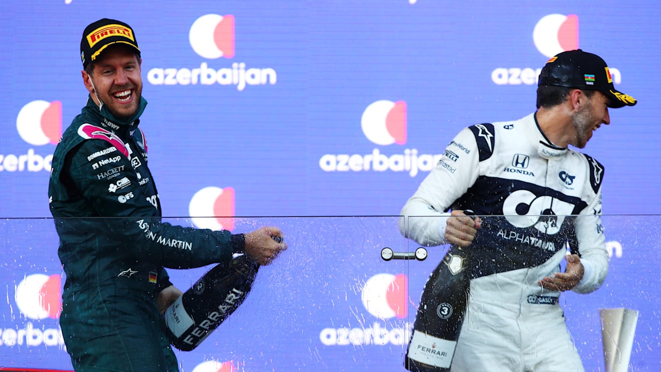 BAKU, AZERBAIJAN - JUNE 06: Second placed Sebastian Vettel of Germany and Aston Martin F1 Team and third placed Pierre Gasly of France and Scuderia AlphaTauri celebrate on the podium during the F1 Grand Prix of Azerbaijan at Baku City Circuit on June 06, 2021 in Baku, Azerbaijan. (Photo by Mark Thompson/Getty Images)