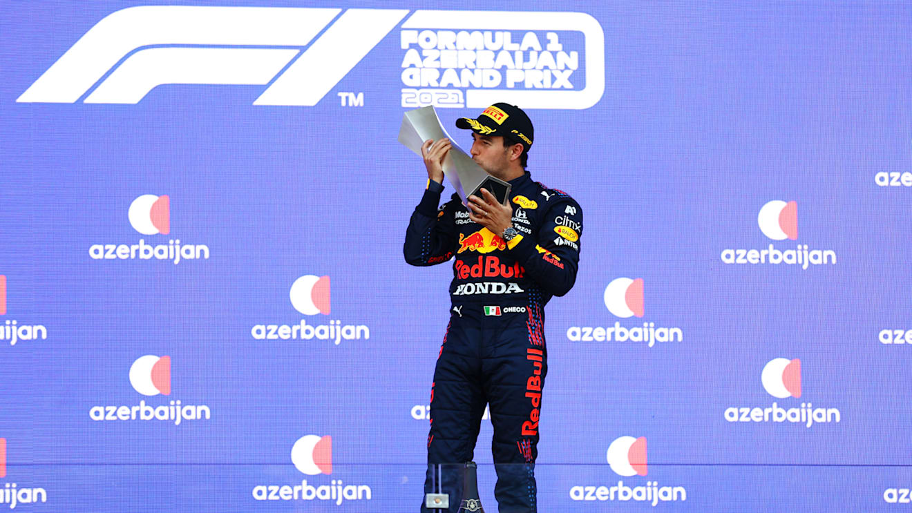 BAKU, AZERBAIJAN - JUNE 06: Race winner Sergio Perez of Mexico and Red Bull Racing celebrates on the podium during the F1 Grand Prix of Azerbaijan at Baku City Circuit on June 06, 2021 in Baku, Azerbaijan. (Photo by Dan Istitene - Formula 1/Formula 1 via Getty Images)