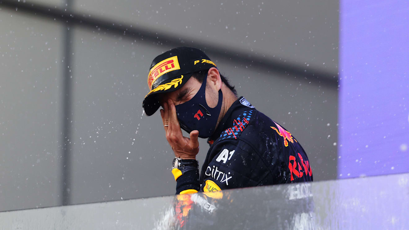 BAKU, AZERBAIJAN - JUNE 06: Race winner Sergio Perez of Mexico and Red Bull Racing celebrates with sparkling wine on the podium during the F1 Grand Prix of Azerbaijan at Baku City Circuit on June 06, 2021 in Baku, Azerbaijan. (Photo by Clive Rose/Getty Images)
