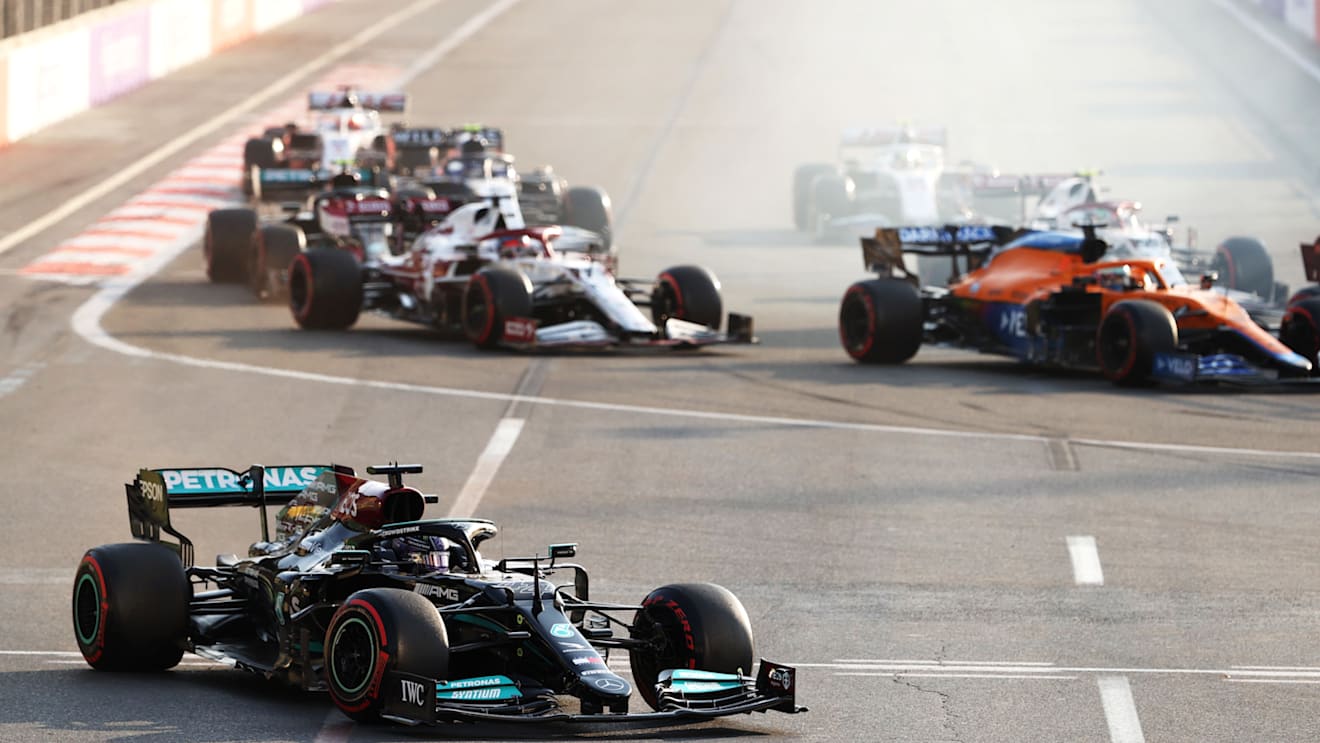 BAKU, AZERBAIJAN - JUNE 06: Lewis Hamilton of Great Britain driving the (44) Mercedes AMG Petronas F1 Team Mercedes W12 runs wide after locking up at the restart following a red flag period during the F1 Grand Prix of Azerbaijan at Baku City Circuit on June 06, 2021 in Baku, Azerbaijan. (Photo by Clive Rose/Getty Images)