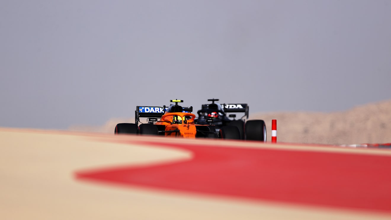 BAHRAIN, BAHRAIN - MARCH 26: Lando Norris of Great Britain driving the (4) McLaren F1 Team MCL35M Mercedes and Yuki Tsunoda of Japan driving the (22) Scuderia AlphaTauri AT02 Honda drive on track during practice ahead of the F1 Grand Prix of Bahrain at Bahrain International Circuit on March 26, 2021 in Bahrain, Bahrain. (Photo by Lars Baron/Getty Images)