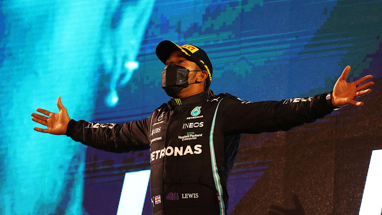 BAHRAIN, BAHRAIN - MARCH 28: Race winner Lewis Hamilton of Great Britain and Mercedes GP celebrates on the podium after the F1 Grand Prix of Bahrain at Bahrain International Circuit on March 28, 2021 in Bahrain, Bahrain. (Photo by Bryn Lennon/Getty Images)