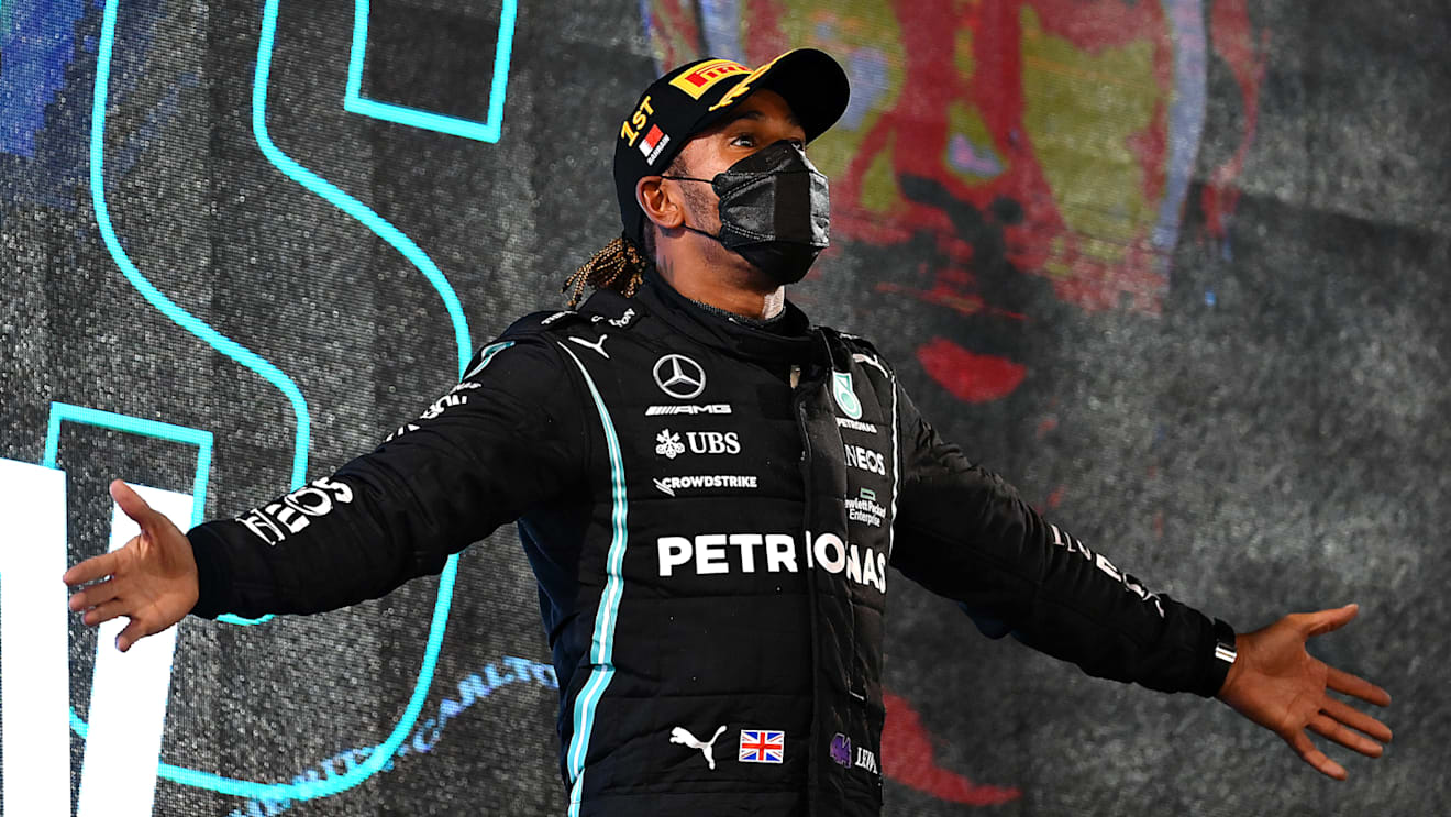 BAHRAIN, BAHRAIN - MARCH 28: Race winner Lewis Hamilton of Great Britain and Mercedes GP celebrates on the podium after the F1 Grand Prix of Bahrain at Bahrain International Circuit on March 28, 2021 in Bahrain, Bahrain. (Photo by Clive Mason - Formula 1/Formula 1 via Getty Images)
