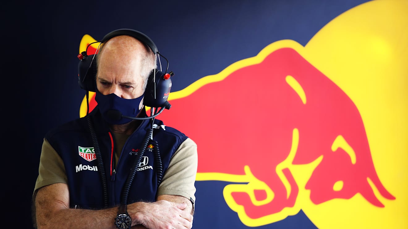Red Bull's design master Adrian Newey watches on from the garage