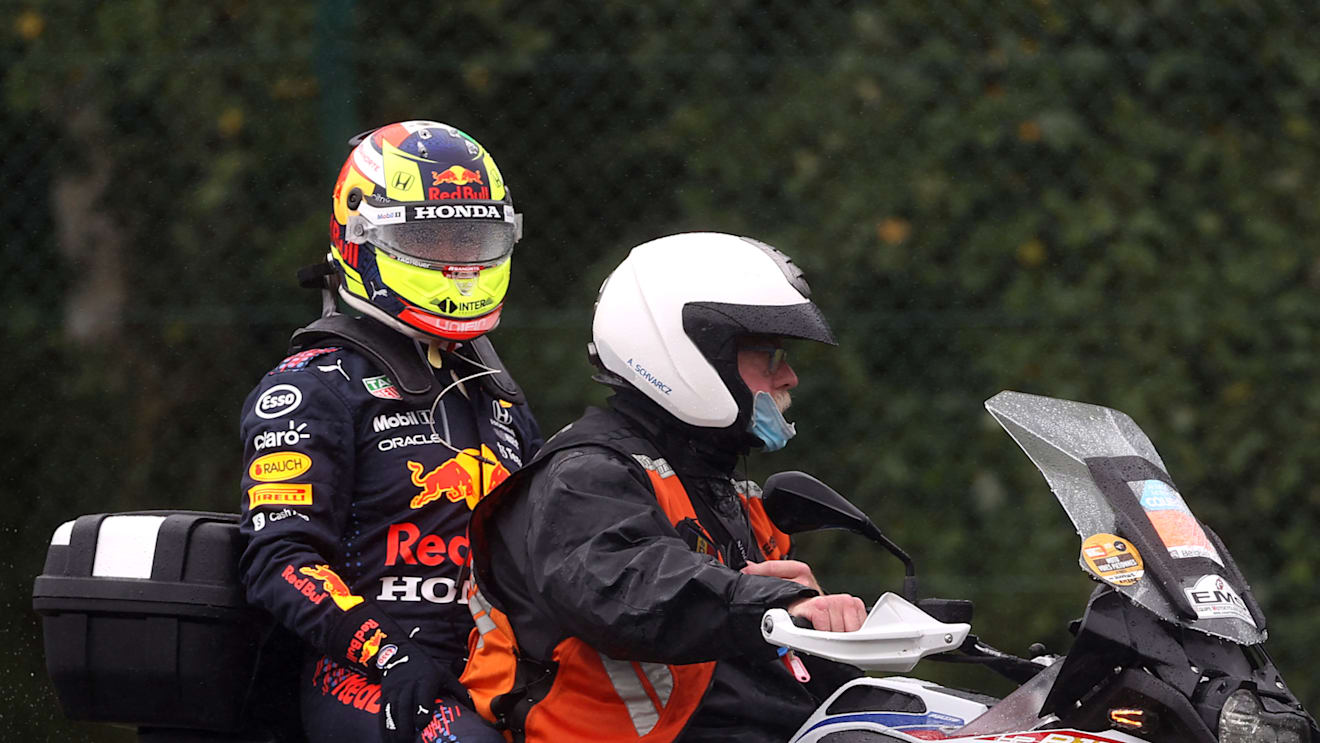 SPA, BELGIUM - AUGUST 29: Sergio Perez of Mexico and Red Bull Racing is given a lift back to the paddock after crashing on his way to the grid prior to the F1 Grand Prix of Belgium at Circuit de Spa-Francorchamps on August 29, 2021 in Spa, Belgium. (Photo by Lars Baron/Getty Images)