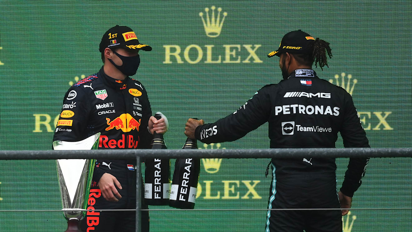 SPA, BELGIUM - AUGUST 29: Race winner Max Verstappen of Netherlands and Red Bull Racing and third placed Lewis Hamilton of Great Britain and Mercedes GP celebrate on the podium during the F1 Grand Prix of Belgium at Circuit de Spa-Francorchamps on August 29, 2021 in Spa, Belgium. (Photo by Dan Mullan/Getty Images)