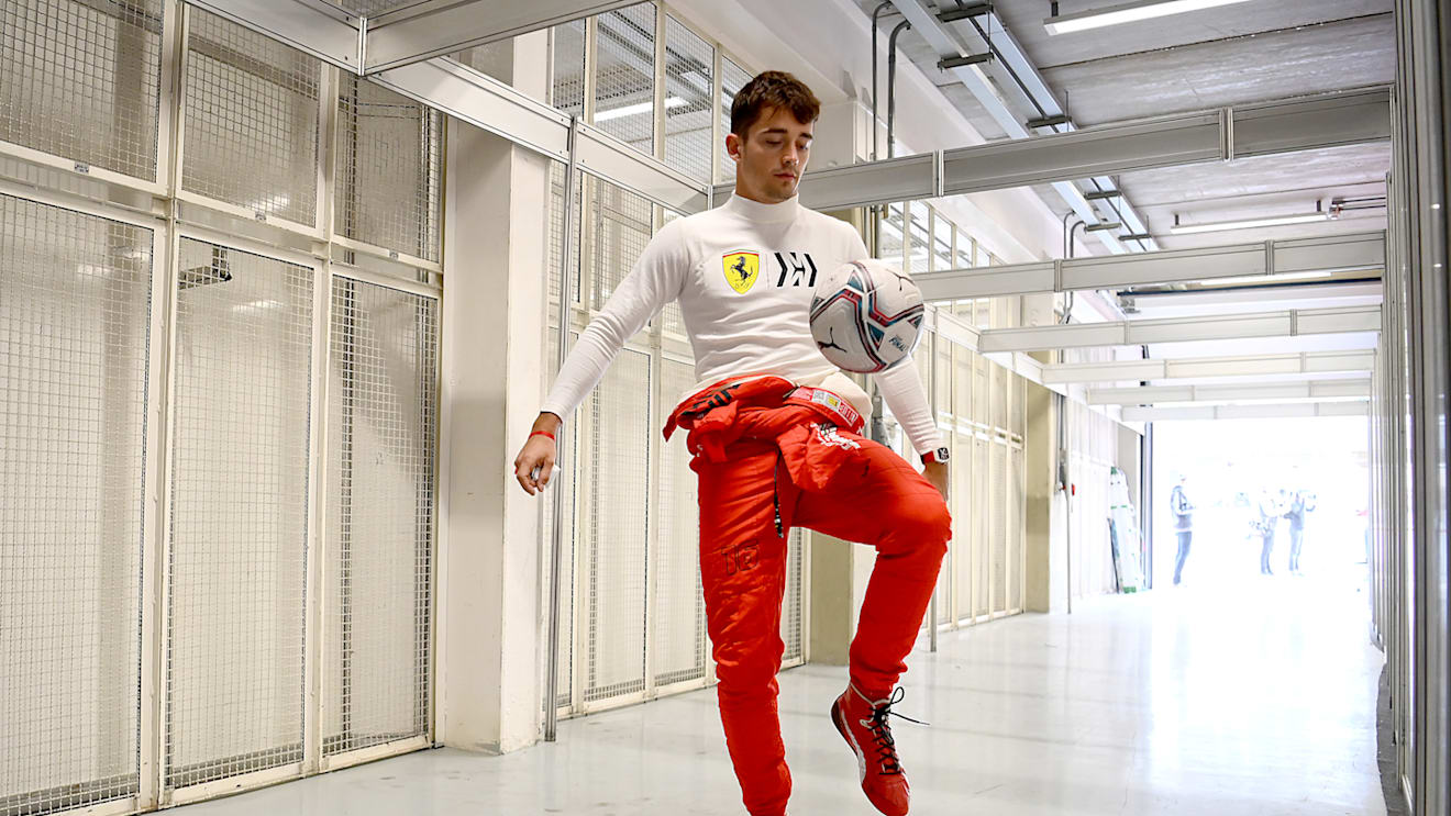 SAO PAULO, BRAZIL - NOVEMBER 12: Charles Leclerc of Monaco and Ferrari warms up by playing football during practice ahead of the F1 Grand Prix of Brazil at Autodromo Jose Carlos Pace on November 12, 2021 in Sao Paulo, Brazil. (Photo by Clive Mason - Formula 1/Formula 1 via Getty Images)