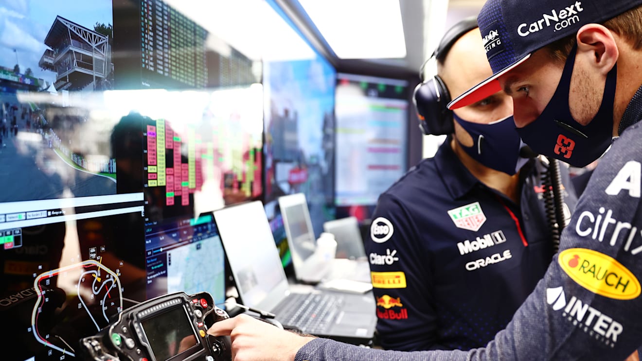 SAO PAULO, BRAZIL - NOVEMBER 13: Max Verstappen of Netherlands and Red Bull Racing talks with race engineer Gianpiero Lambiase in the garage before the sprint ahead of the F1 Grand Prix of Brazil at Autodromo Jose Carlos Pace on November 13, 2021 in Sao Paulo, Brazil. (Photo by Mark Thompson/Getty Images)