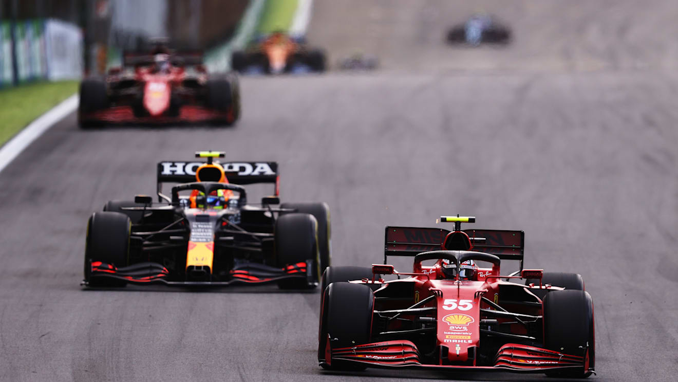 SAO PAULO, BRAZIL - NOVEMBER 13: Carlos Sainz of Spain driving the (55) Scuderia Ferrari SF21 leads Sergio Perez of Mexico driving the (11) Red Bull Racing RB16B Honda during the sprint ahead of the F1 Grand Prix of Brazil at Autodromo Jose Carlos Pace on November 13, 2021 in Sao Paulo, Brazil. (Photo by Lars Baron/Getty Images)