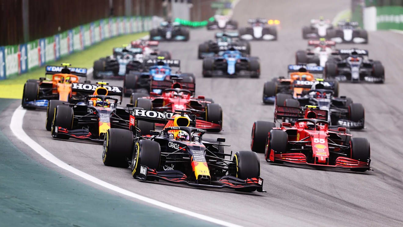 SAO PAULO, BRAZIL - NOVEMBER 13: Max Verstappen of the Netherlands driving the (33) Red Bull Racing RB16B Honda leads Sergio Perez of Mexico driving the (11) Red Bull Racing RB16B Honda and Carlos Sainz of Spain driving the (55) Scuderia Ferrari SF21 and during the sprint ahead of the F1 Grand Prix of Brazil at Autodromo Jose Carlos Pace on November 13, 2021 in Sao Paulo, Brazil. (Photo by Lars Baron/Getty Images)