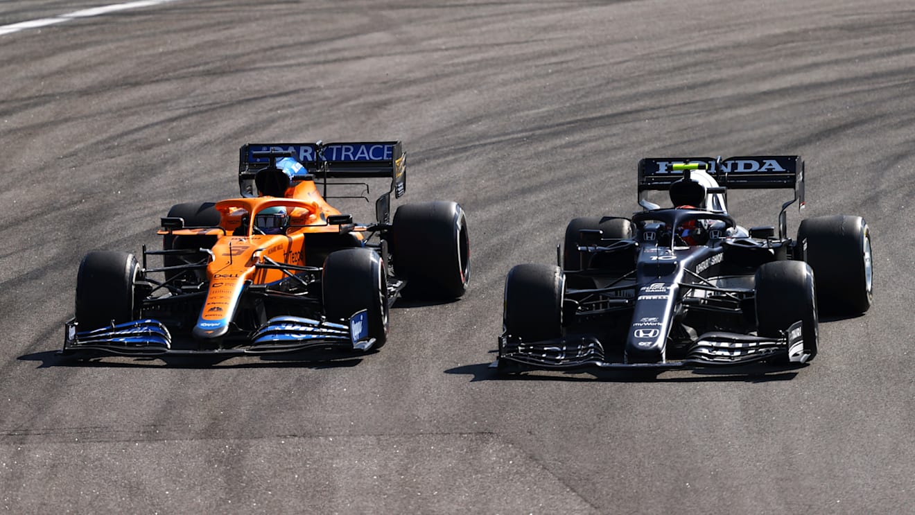 SAO PAULO, BRAZIL - NOVEMBER 14: Pierre Gasly of France driving the (10) Scuderia AlphaTauri AT02 Honda leads Daniel Ricciardo of Australia driving the (3) McLaren F1 Team MCL35M Mercedes during the F1 Grand Prix of Brazil at Autodromo Jose Carlos Pace on November 14, 2021 in Sao Paulo, Brazil. (Photo by Bryn Lennon - Formula 1/Formula 1 via Getty Images)