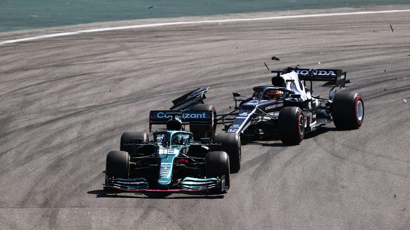 SAO PAULO, BRAZIL - NOVEMBER 14: Yuki Tsunoda of Japan driving the (22) Scuderia AlphaTauri AT02 Honda collides with Lance Stroll of Canada driving the (18) Aston Martin AMR21 Mercedes during the F1 Grand Prix of Brazil at Autodromo Jose Carlos Pace on November 14, 2021 in Sao Paulo, Brazil. (Photo by Bryn Lennon - Formula 1/Formula 1 via Getty Images)