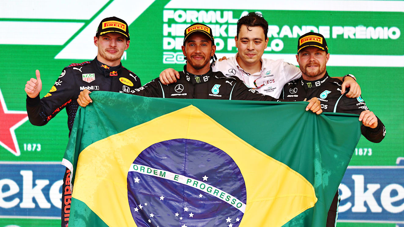 SAO PAULO, BRAZIL - NOVEMBER 14: Race winner Lewis Hamilton of Great Britain and Mercedes GP, second placed Max Verstappen of Netherlands and Red Bull Racing and third placed Valtteri Bottas of Finland and Mercedes GP celebrate on the podium during the F1 Grand Prix of Brazil at Autodromo Jose Carlos Pace on November 14, 2021 in Sao Paulo, Brazil. (Photo by Mark Thompson/Getty Images)