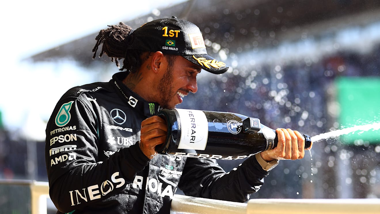 SAO PAULO, BRAZIL - NOVEMBER 14: Race winner Lewis Hamilton of Great Britain and Mercedes GP celebrates on the podium with sparkling wine during the F1 Grand Prix of Brazil at Autodromo Jose Carlos Pace on November 14, 2021 in Sao Paulo, Brazil. (Photo by Bryn Lennon - Formula 1/Formula 1 via Getty Images)