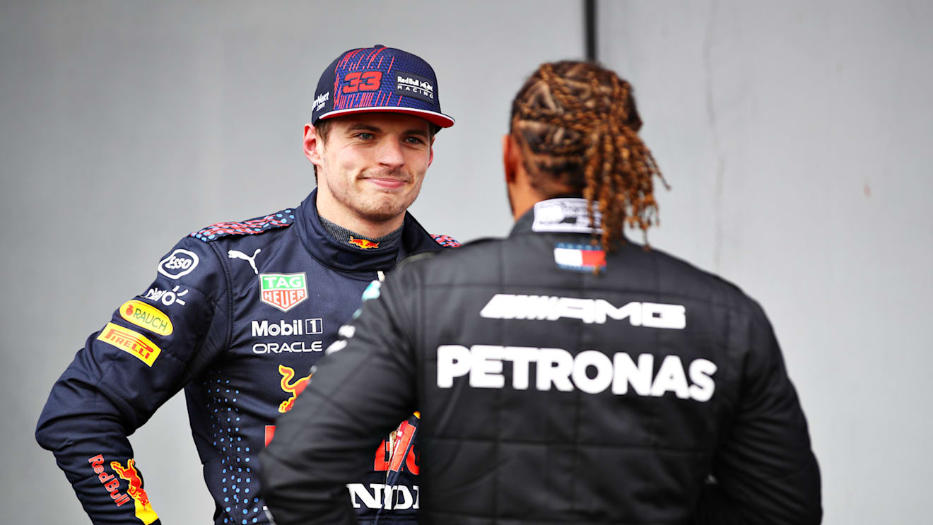 IMOLA, ITALY - APRIL 17: Third place qualifier Max Verstappen of Netherlands and Red Bull Racing talks with pole position qualifier Lewis Hamilton of Great Britain and Mercedes GP in parc ferme during qualifying ahead of the F1 Grand Prix of Emilia Romagna at Autodromo Enzo e Dino Ferrari on April 17, 2021 in Imola, Italy. (Photo by Mark Thompson/Getty Images)