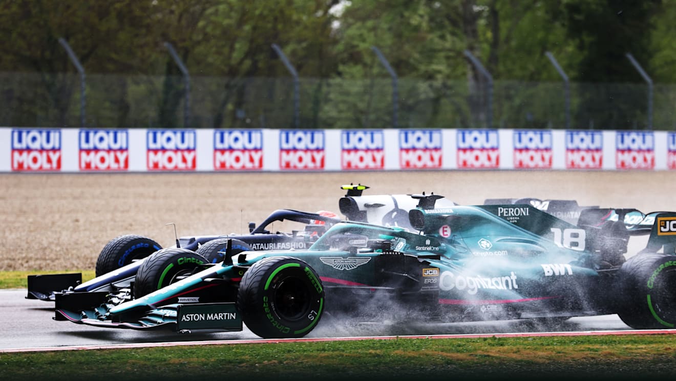 IMOLA, ITALY - APRIL 18: Pierre Gasly of France driving the (10) Scuderia AlphaTauri AT02 Honda and Lance Stroll of Canada driving the (18) Aston Martin AMR21 Mercedes compete for position on track during the F1 Grand Prix of Emilia Romagna at Autodromo Enzo e Dino Ferrari on April 18, 2021 in Imola, Italy. (Photo by Bryn Lennon/Getty Images)
