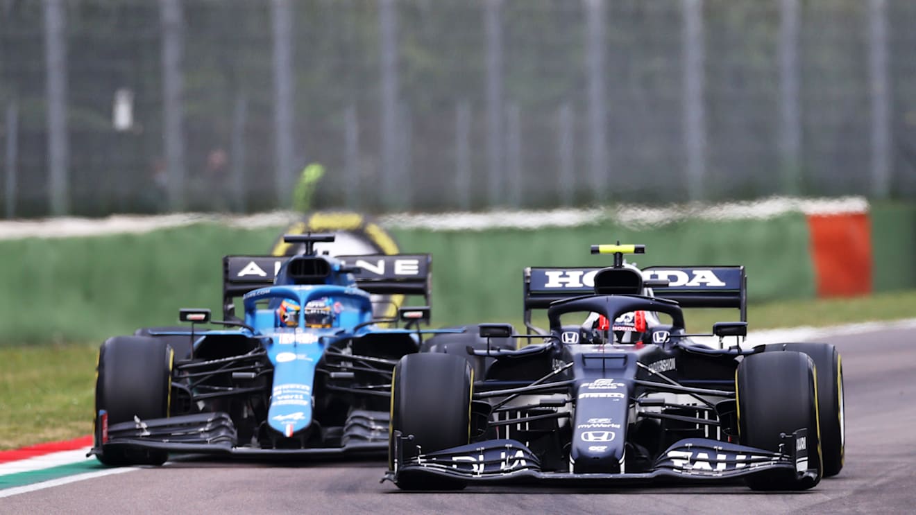 IMOLA, ITALY - APRIL 18: Pierre Gasly of France driving the (10) Scuderia AlphaTauri AT02 Honda and Fernando Alonso of Spain driving the (14) Alpine A521 Renault compete for position on track during the F1 Grand Prix of Emilia Romagna at Autodromo Enzo e Dino Ferrari on April 18, 2021 in Imola, Italy. (Photo by Lars Baron/Getty Images)