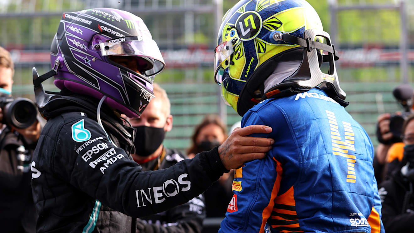 IMOLA, ITALY - APRIL 18: Second placed Lewis Hamilton of Great Britain and Mercedes GP and third placed Lando Norris of Great Britain and McLaren F1 hug in parc ferme during the F1 Grand Prix of Emilia Romagna at Autodromo Enzo e Dino Ferrari on April 18, 2021 in Imola, Italy. (Photo by Bryn Lennon/Getty Images)