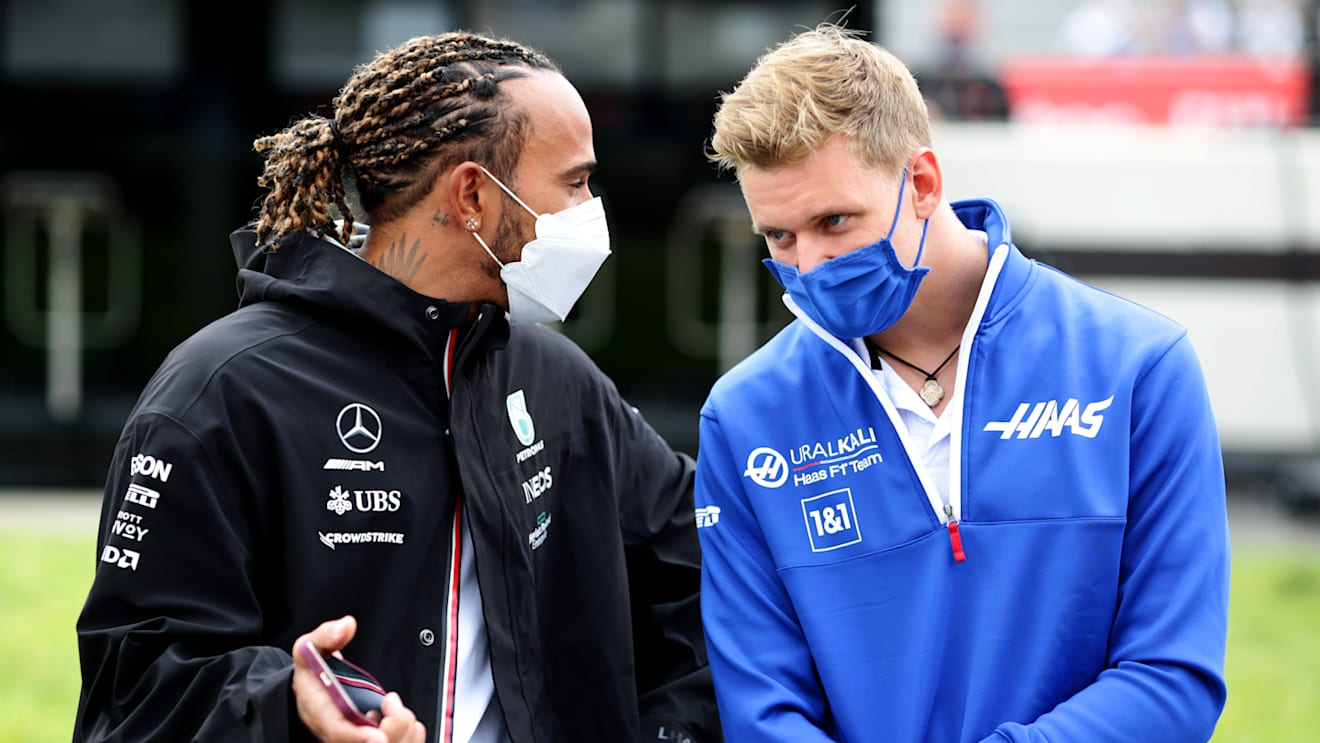 LE CASTELLET, FRANCE - JUNE 20: Lewis Hamilton of Great Britain and Mercedes GP talks with Mick Schumacher of Germany and Haas F1 during the F1 Grand Prix of France at Circuit Paul Ricard on June 20, 2021 in Le Castellet, France. (Photo by Peter Fox/Getty Images)