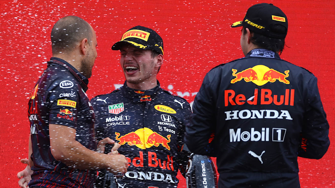 LE CASTELLET, FRANCE - JUNE 20: Red Bull Racing race engineer Gianpiero Lambiase, race winner Max Verstappen of Netherlands and Red Bull Racing and third placed Sergio Perez of Mexico and Red Bull Racing celebrate with sparkling wine on the podium during the F1 Grand Prix of France at Circuit Paul Ricard on June 20, 2021 in Le Castellet, France. (Photo by Bryn Lennon - Formula 1/Formula 1 via Getty Images)