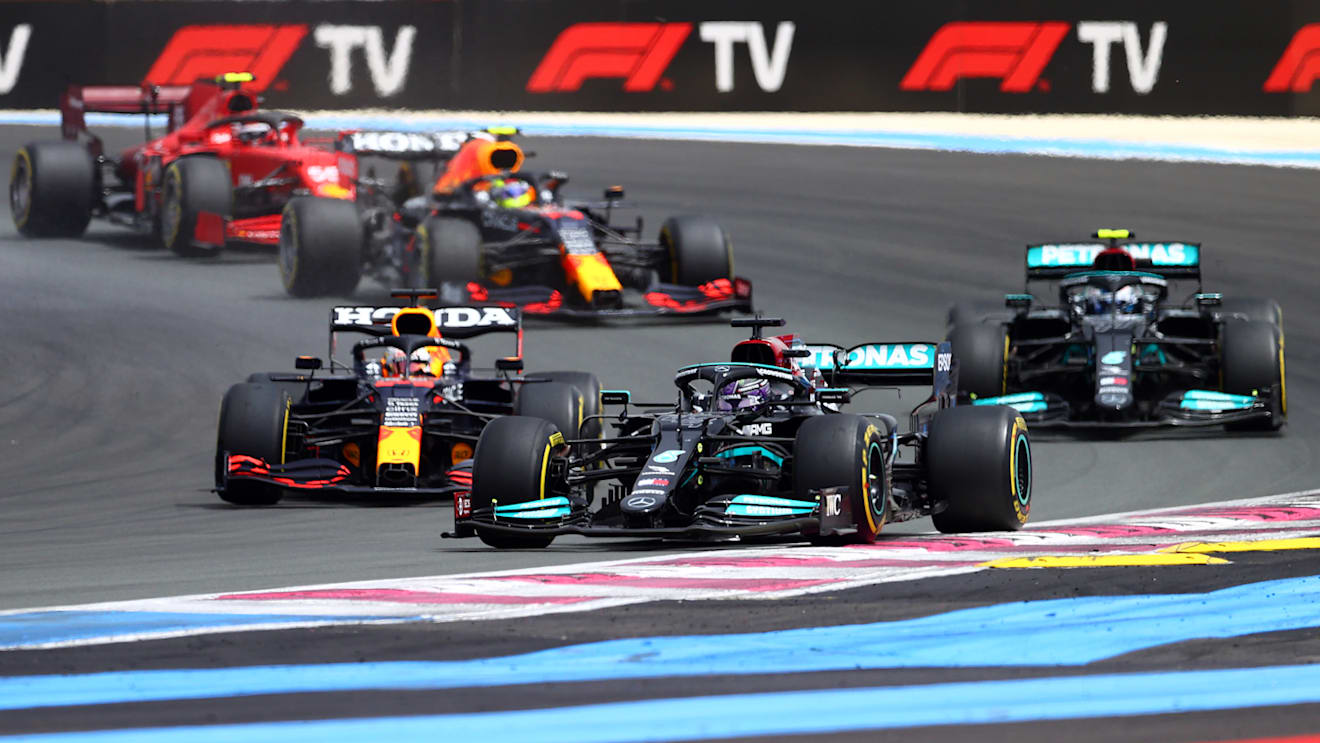LE CASTELLET, FRANCE - JUNE 20: Lewis Hamilton of Great Britain driving the (44) Mercedes AMG Petronas F1 Team Mercedes W12 leads Max Verstappen of the Netherlands driving the (33) Red Bull Racing RB16B Honda and the rest of the field at the start of the race during the F1 Grand Prix of France at Circuit Paul Ricard on June 20, 2021 in Le Castellet, France. (Photo by Dan Istitene - Formula 1/Formula 1 via Getty Images)